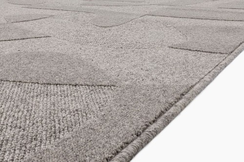 Dywan wełniany Agnella Ladnini Morphic Botanica szary - zbliżenie na runo 3D i obszycie wełniane