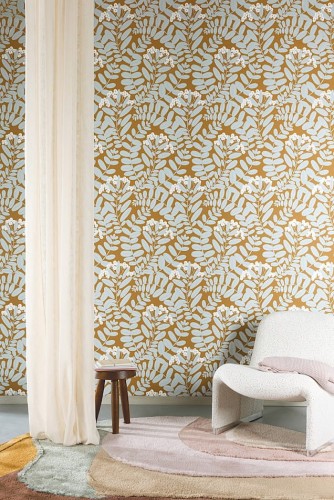 Biały fotel boucle w salonie z tapetą Khroma Mysa YSA005 Bodie Ochre.jpg