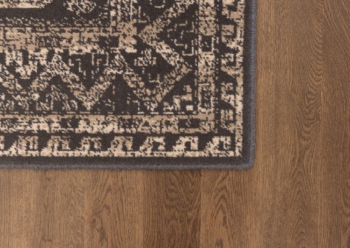 Dywan wełniany na ciemnej podłodze Agnella Ballata Aneko brąz.jpg