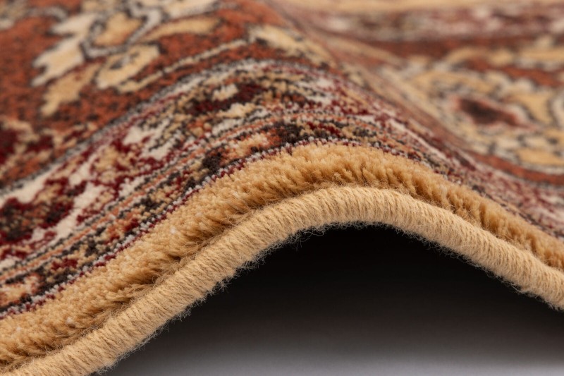 Obszycie wełniane dywanu Agnella Isfahan Leyla w kolorze bursztyn