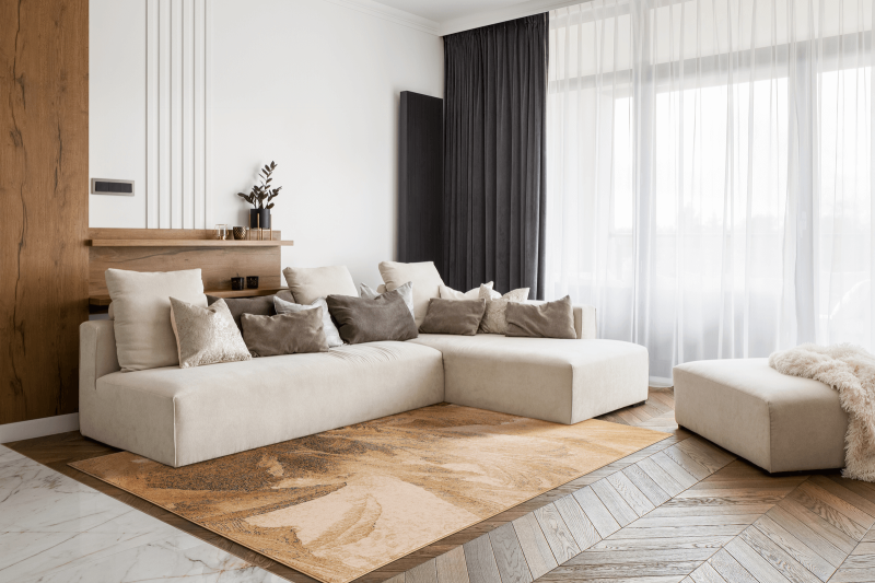 Dywan wełniany Agnella Isfahan Lotis kolor beżowy w nowoczesnym salonie  na tle kremowej kanapy