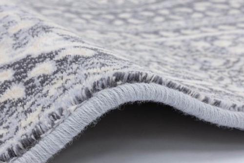 Dywan wełniany Agnella Isfahan Nour jasny niebieski - zdjęcie obszycia dywanu