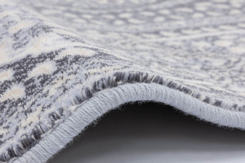 Dywan wełniany Agnella Isfahan Nour jasny niebieski - zdjęcie obszycia dywanu