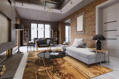 Dywan wełniany nowoczesny Agnella Isfahan Ornan w kolorze sahara w salonie w stylu loft z jasno szarą kanapą i ścianą z cegieł