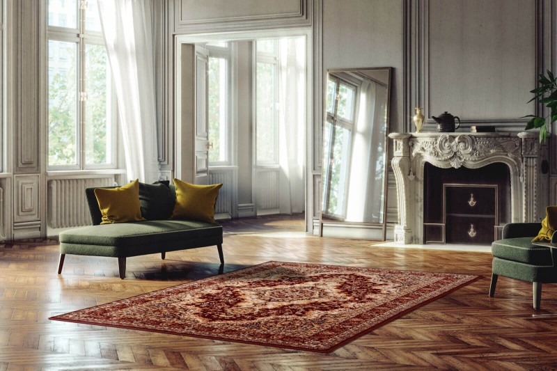 Dywan wełniany klasyczny Agnella Isfahan Almas kolor rubin w pomieszczeniu pałacowym ze sztukaterią