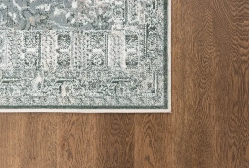 Na ciemnej podłodze dywan vintage FD Sensi Jim miętowy