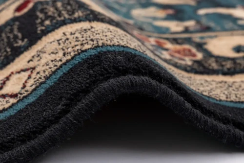 Zbliżenie runa i obszycia dywanu Agnella Isfahan Amara szmaragd