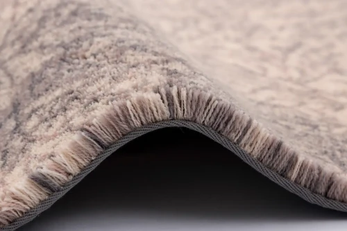 Dywan wełniany Calisia Corail piaskowy wysokość runa i wykończenie taśmą.webp