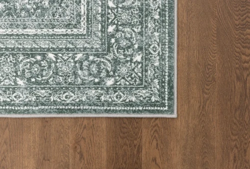 Dywan vintage FD Lida Herman malachit na ciemnej podłodze