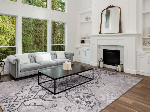 Dywan wełniany Agnella Opal Tomas beżowy (binding) w salonie przy kominku