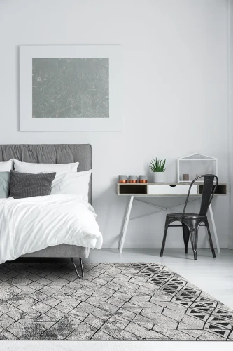 Dywan wełniany Agnella Opal Bateja jasny szary (binding) w sypialni