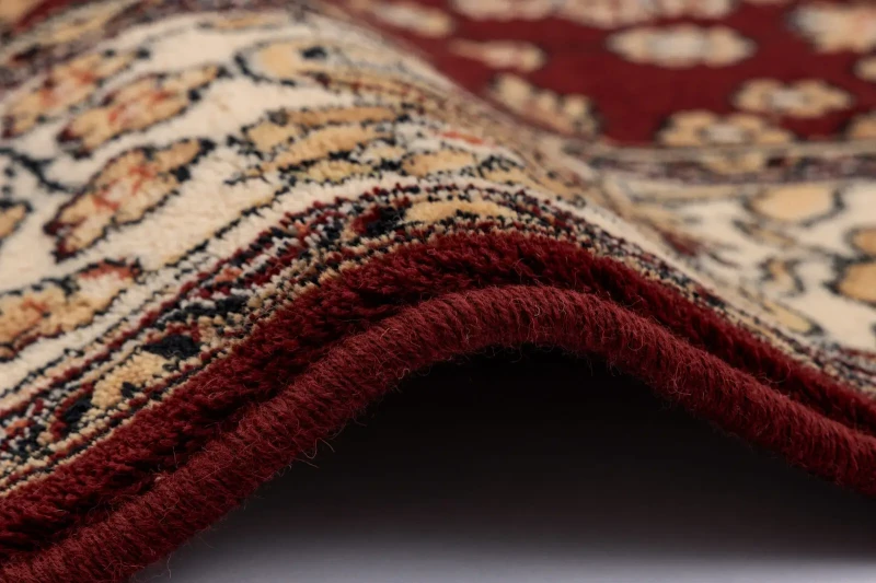Dywan wełniany Agnella klasyczny Isfahan Kantabria rubin - obszycie dywanu