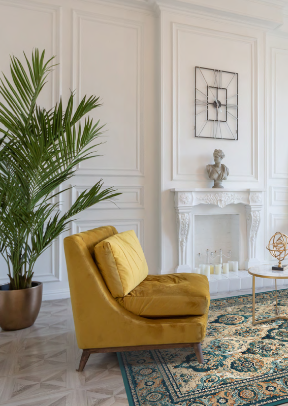 Dywan wełniany Agnella Isfahan Forenza szmaragd w aranżacji z żółtym fotelem