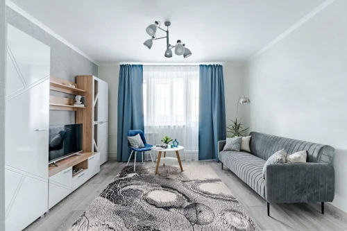 Dywan wełniany nowoczesny Agnella Isfahan Bellona jasny szary w pokoju dziennym