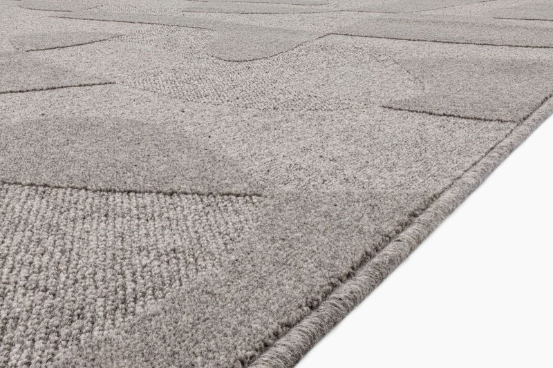 Dywan wełniany Agnella Ladnini Morphic Botanica szary - zbliżenie na runo 3D i obszycie wełniane