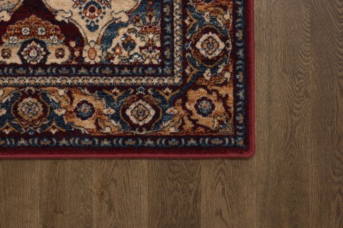 Róg dywanu wełnianego Agnella Isfahan Forenza kolor bordowy w rozmiarze 1,33x1,80 m