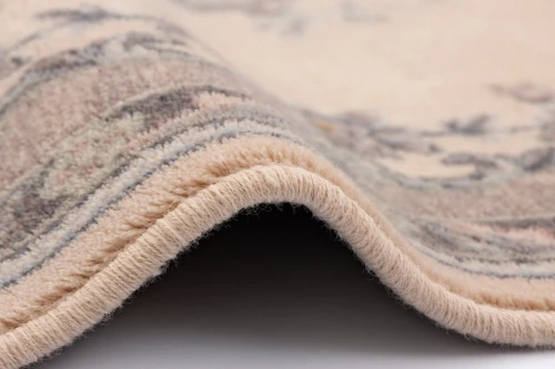 Dywan wełniany Agnella Isfahan Dafne alabastrowy - zdjęcie obszycia dywanu